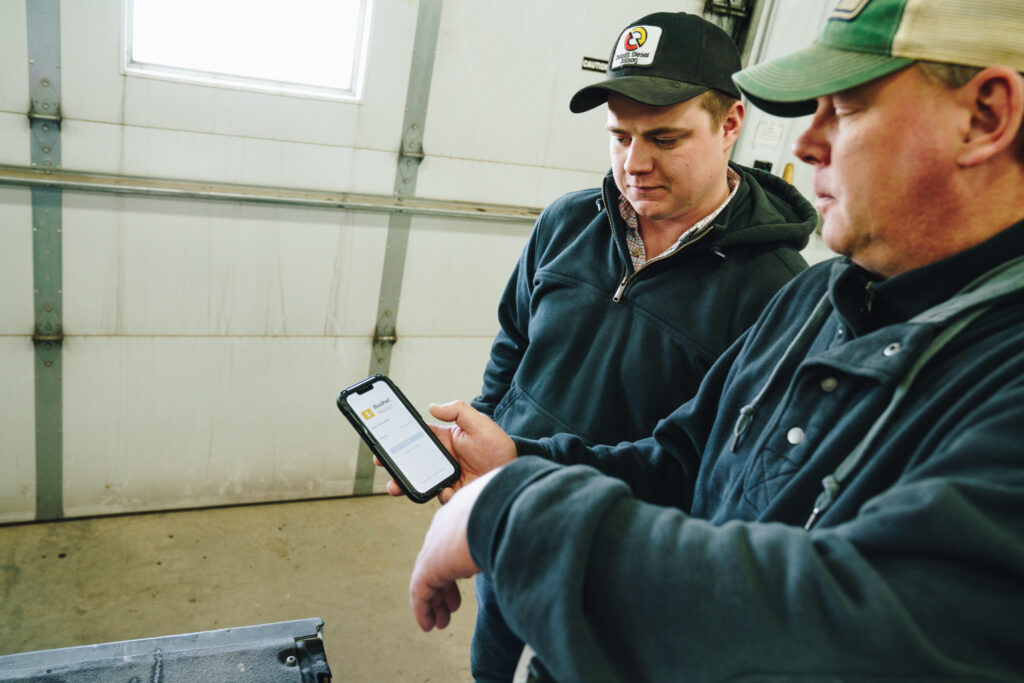 Two men looking at mobile device screen