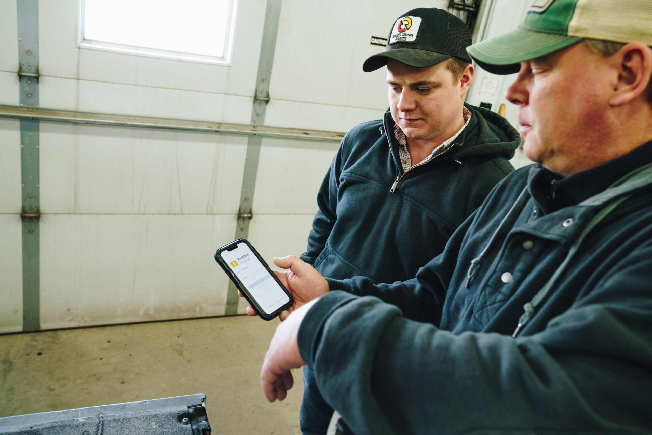 Two men looking at mobile device screen