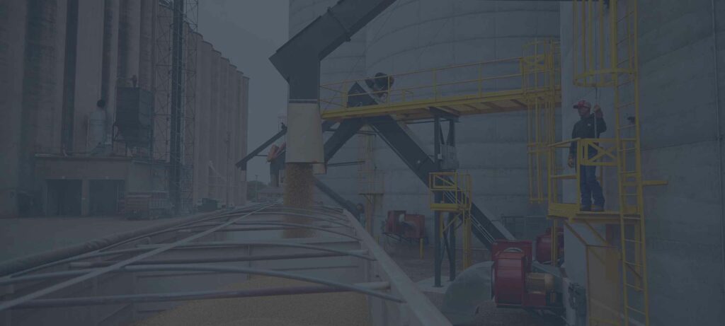 Image of grain auger loading grain into a parked semi