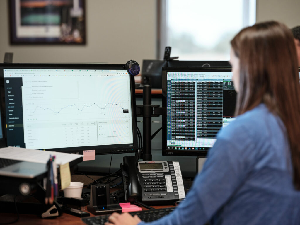 Person sitting behind computer screen.