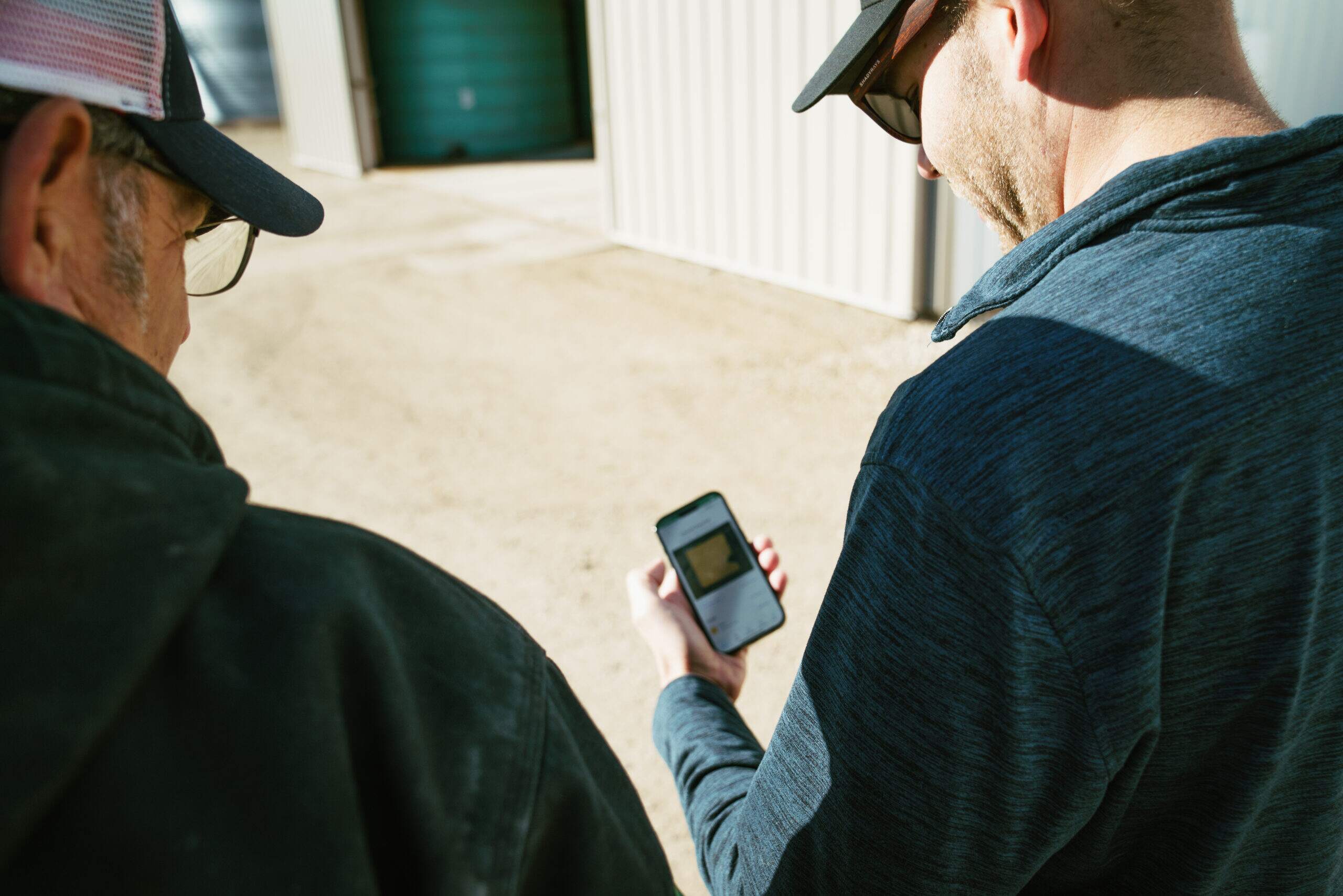 Farmers looking at a mobile phone