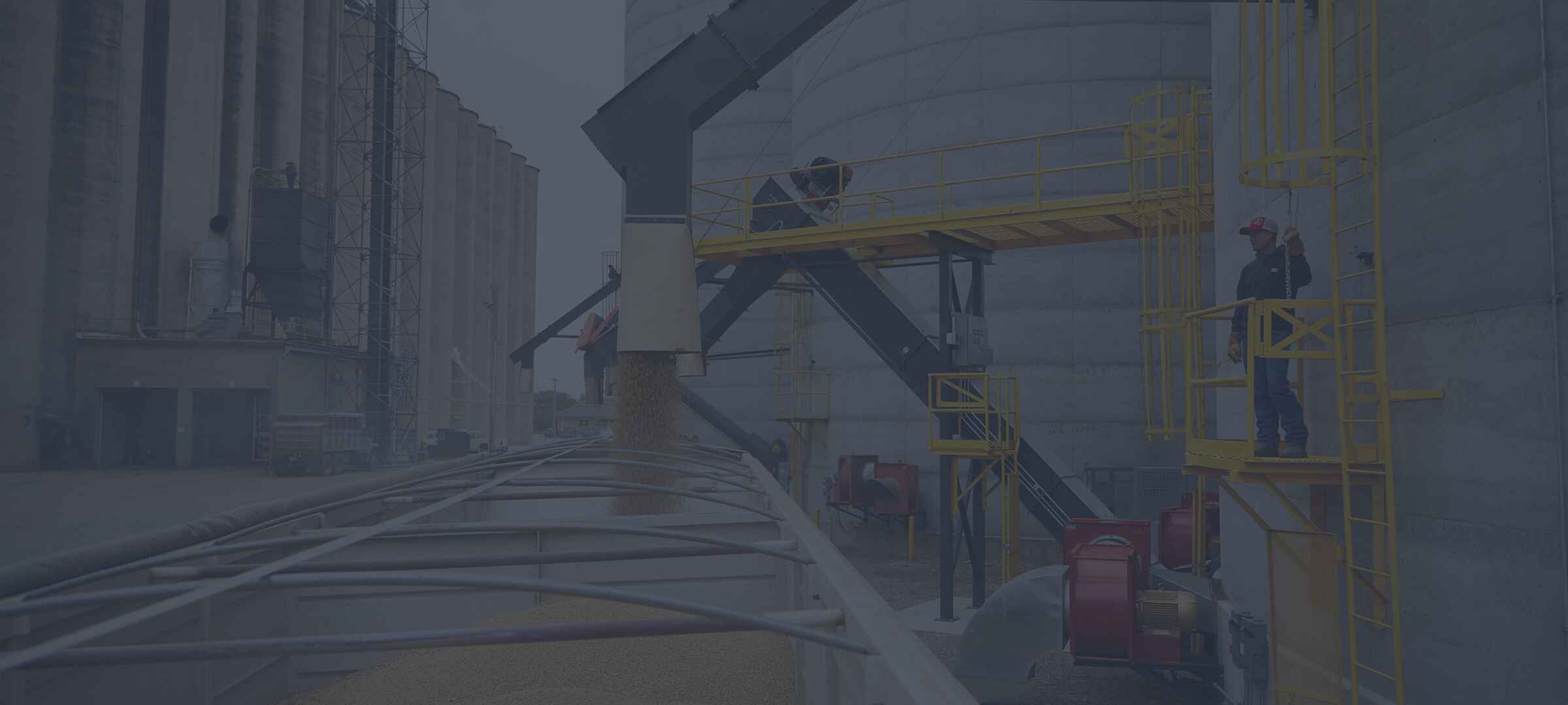 Image of grain auger loading grain into a parked semi