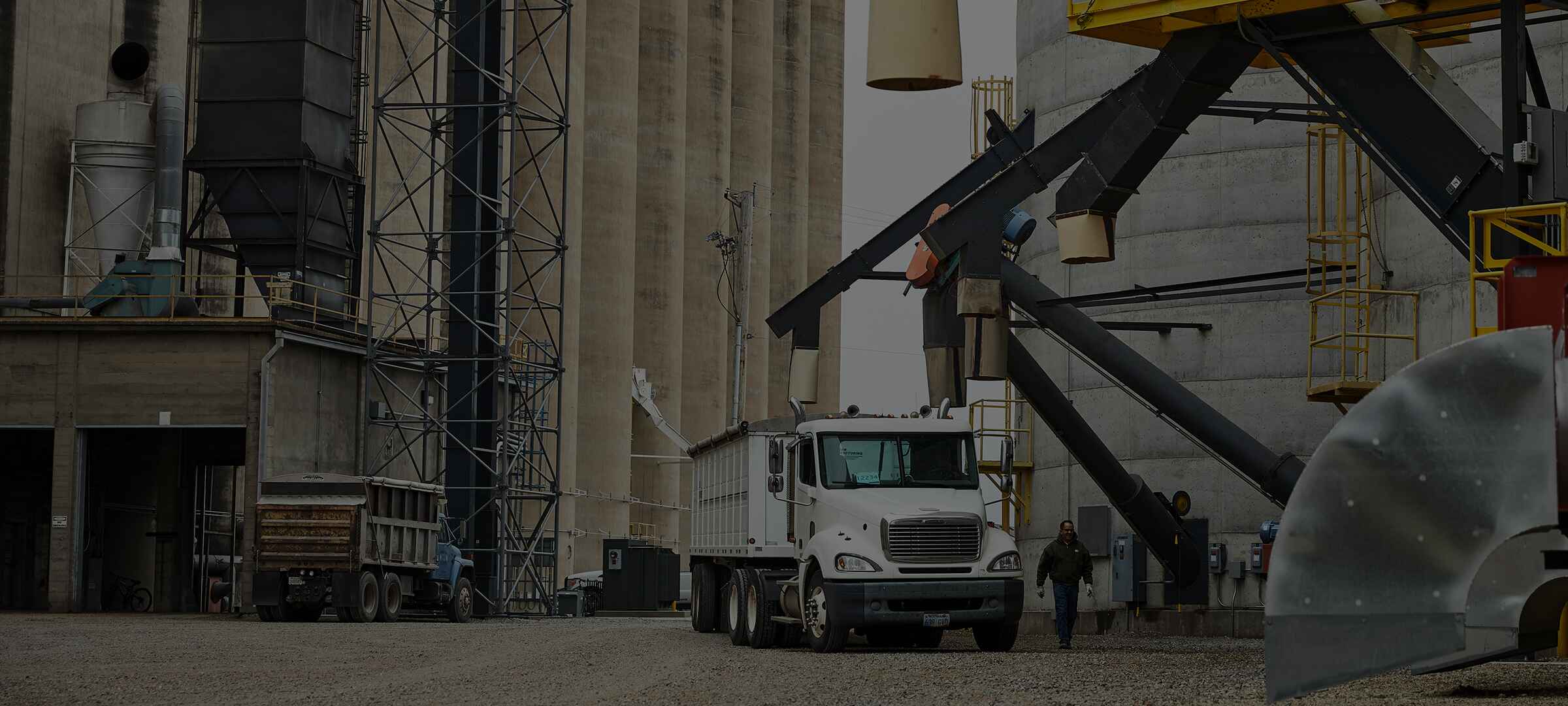 An image of a semi truck getting loaded with grain while at a grain elevator