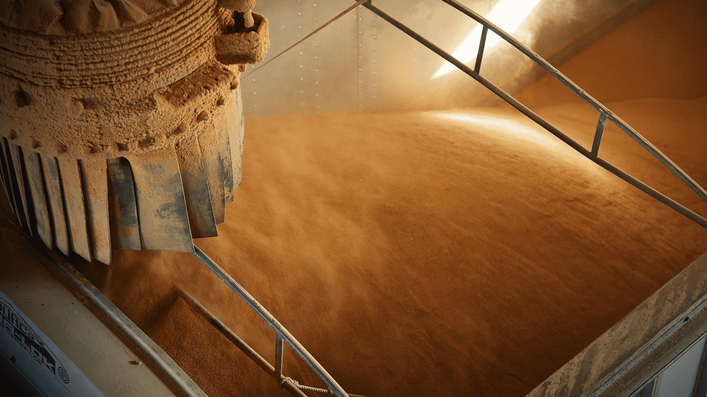 The top of a grain truck being loaded by an auger